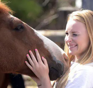 Student Julian Wert plays a part in an exercise about overcoming obstacles by trying to get horses to go to certain corners of the corral during a leadership class Wednesday, Sept. 16, 2015, in Castleford.